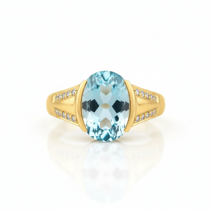 Gold ring with a blue gemstone on a white background