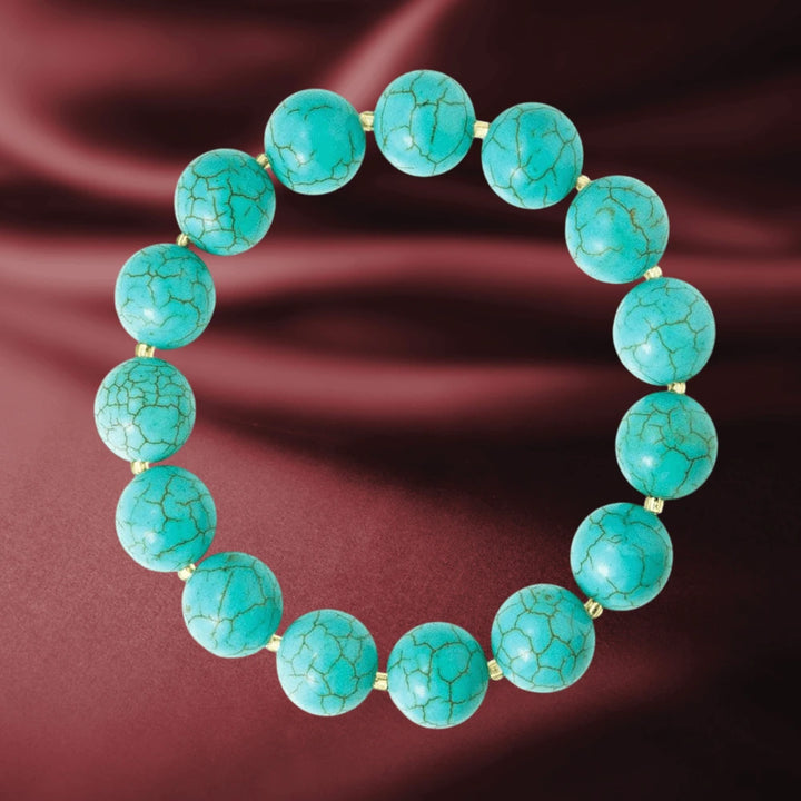 Turquoise and Tiger's Eye Bracelet featuring round turquoise gemstone beads interspersed with gold-plated accents, designed for female jewelry enthusiasts.