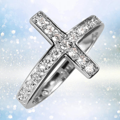 Reclining Cross Rhodium Ring made of sterling silver with rhodium plating, featuring sparkling stones set in a female-designed cross-shaped band, perfect as elegant jewelry.