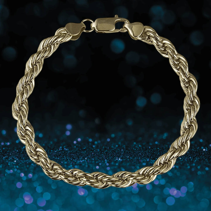 Atlantic Men's Bracelet in gold-plated stainless steel featuring a twisted rope design, displayed against a dark background with blue bokeh accents, perfect for men's jewelry collections.