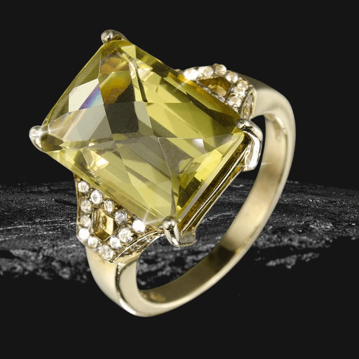 Orchard Ring featuring a large rectangular yellow gemstone set in sterling silver with gold plating, accented by small clear stones, designed for women’s jewelry.
