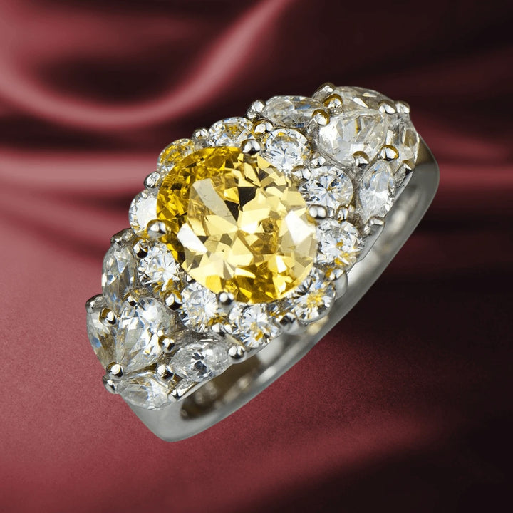 Rhodium Canaria Ring featuring a large yellow gemstone centerpiece, surrounded by sparkling clear stones set in sterling silver with rhodium plating, designed for women.