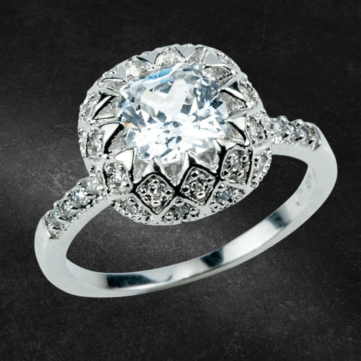 Tangier Ring featuring a sterling silver band with rhodium plating, adorned with a large central gemstone surrounded by intricate smaller stones, designed for women’s jewelry.