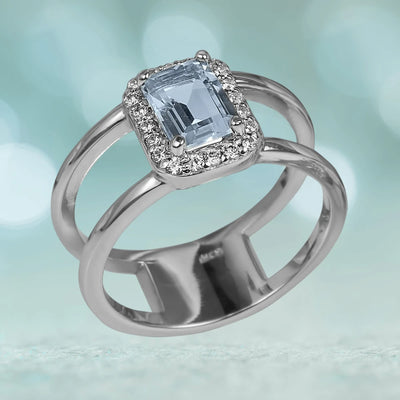 Destiny Topaz Ring featuring a rectangular light blue topaz center stone surrounded by small clear stones, set in rhodium-plated sterling silver designed for female jewelry.