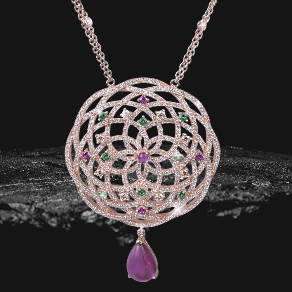 Granada Pendant sterling silver necklace plated in rose gold featuring an intricate circular lattice design with green and purple gemstones and a purple teardrop charm.
