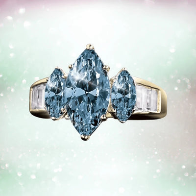 Capri Marquise Ring featuring three marquise-cut blue stones set in sterling silver with gold plating, designed as elegant female jewelry.