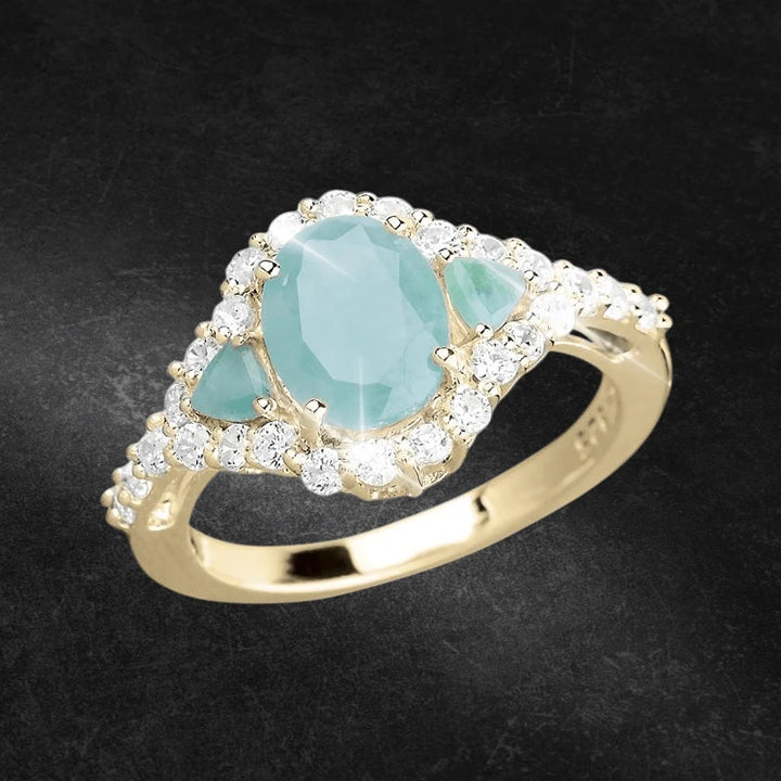 Sakota Emerald Ring featuring a sterling silver band with gold plating, showcasing a central emerald stone surrounded by sparkling clear stones, designed for women.