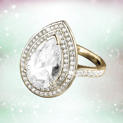 Pasha Pearshape Ring featuring a pear-shaped clear gemstone set in sterling silver with gold plating, accented by two rows of small sparkling stones on the band.