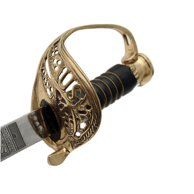 Ornate gold sword hilt with an engraved guard and black wrapped handle attached to a partially visible patterned blade on a white background