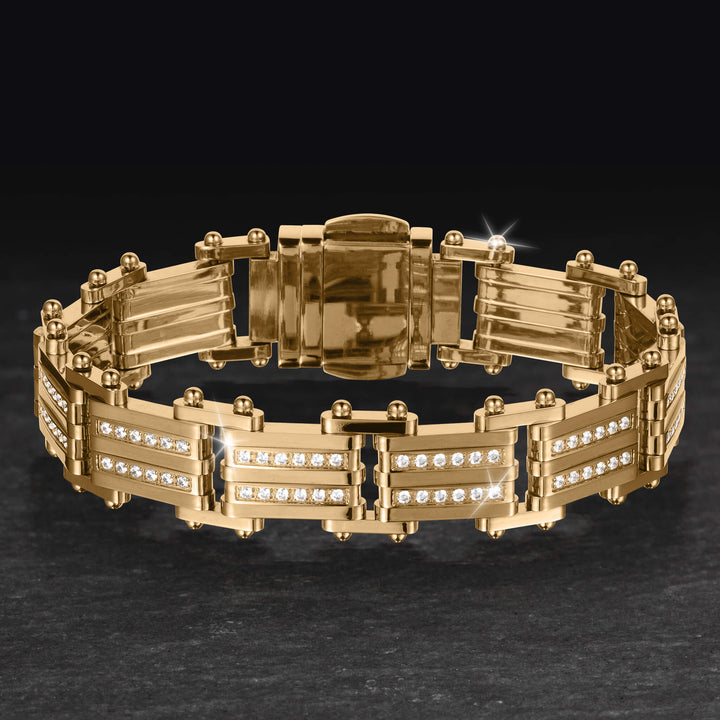 Modex Bracelet in polished gold tone metal with crystal accented panels and secure fold over clasp displayed on a dark surface Up To 75% Off Retail