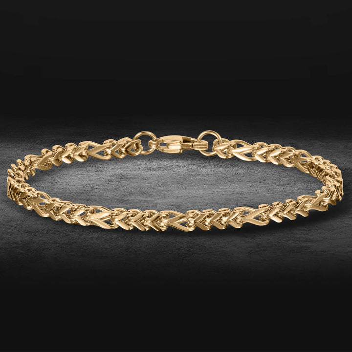 Kodiak Steel Collection gold braided chain bracelet with secure clasp on a dark background polished jewelry piece up to 75% off retail