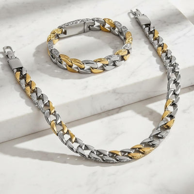 Two-tone silver and gold chain necklace and bracelet on a light . Curb Vine Men's Set by Daniel Steigerbackground