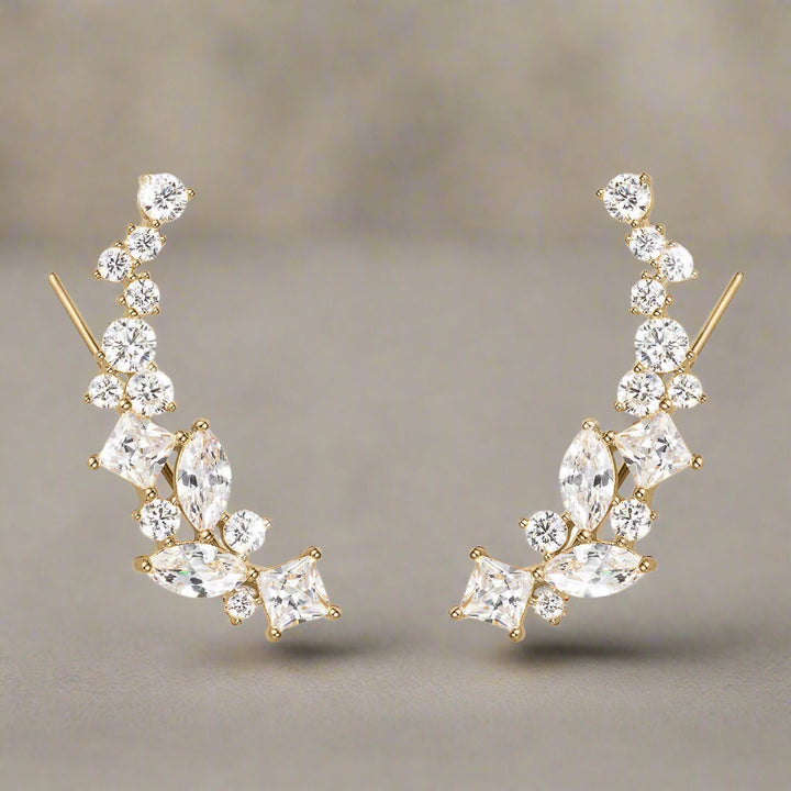 Gold and crystal earrings on a white background