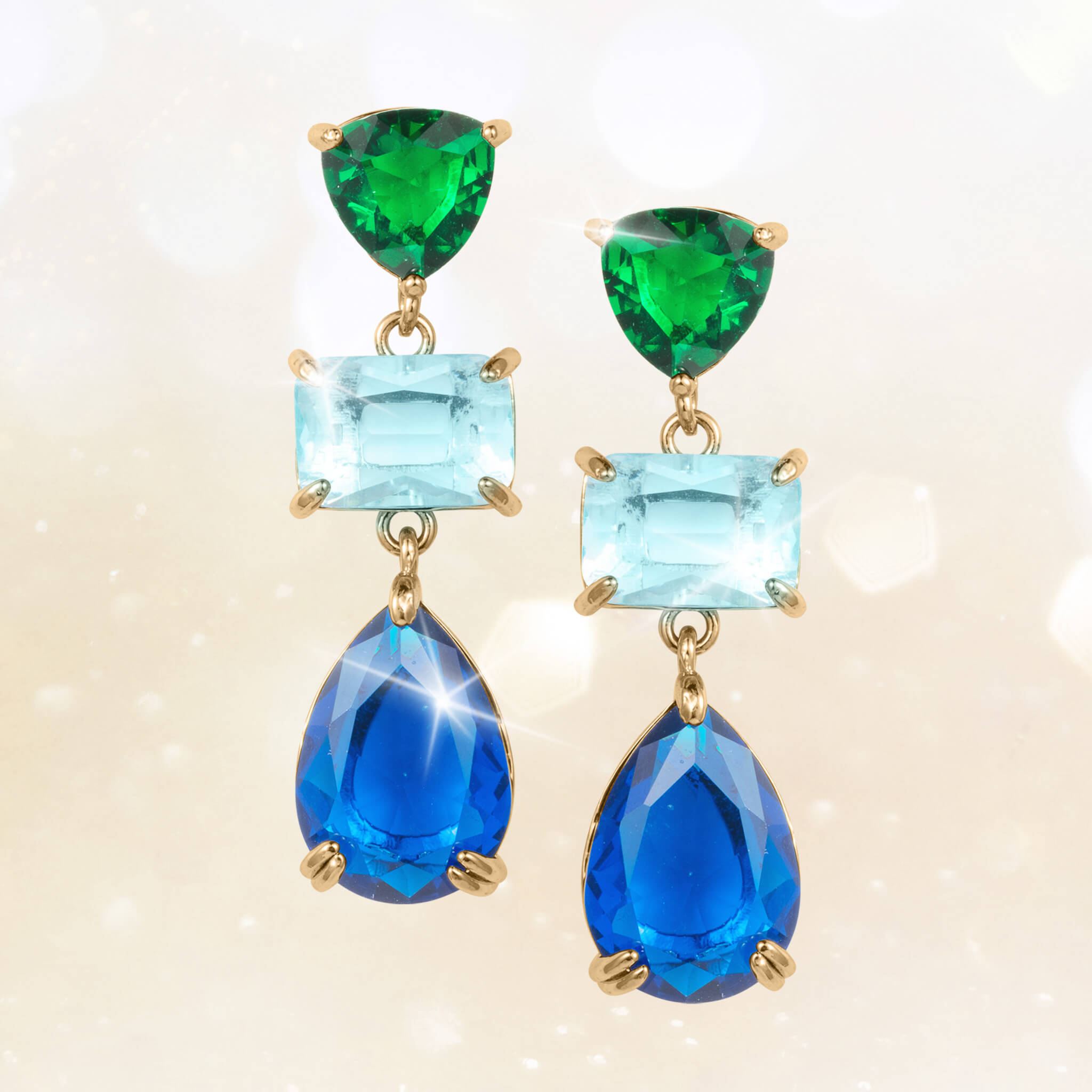 Elegant gold-plated earrings from the Midnight Riviera Collection featuring green, light blue, and deep blue gemstones, offering a captivating jewelry piece Up To 75% Off Retail.