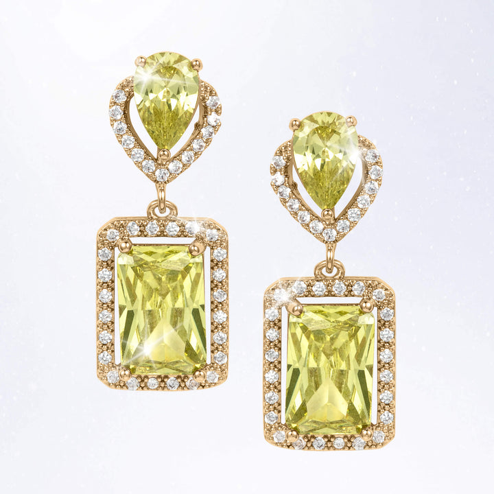 Gold tone drop earrings featuring faceted yellow green gemstones, rectangular pendant settings, and sparkling clear accent stones around the edges
