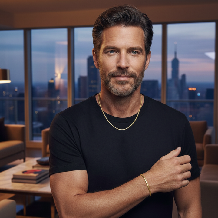 Man in a black t-shirt standing in a modern living room with cityscape view
