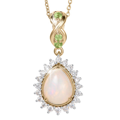 Opal Dew Drop Pendant featuring a luminous opal teardrop surrounded by sparkling stones with a gold chain and green gemstone accent. Up To 75% Off Retail