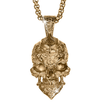 Ornate gold skull pendant necklace featuring intricate sculpted details and a chain with a dramatic gothic jewelry design