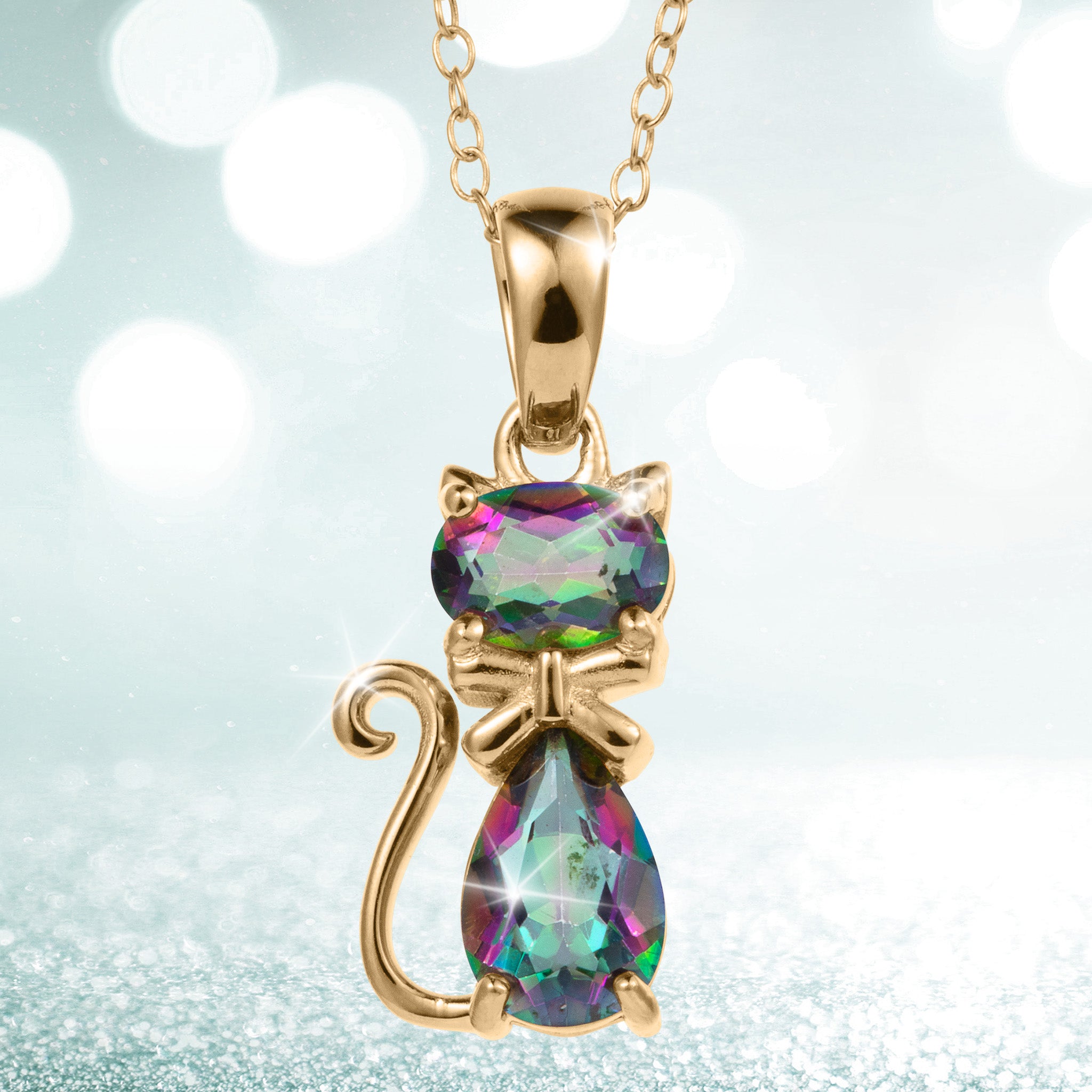 Mystic Kitten Pendant featuring a gold tone cat with vivid iridescent gemstones on a delicate chain against a sparkling background Up To 75% Off Retail