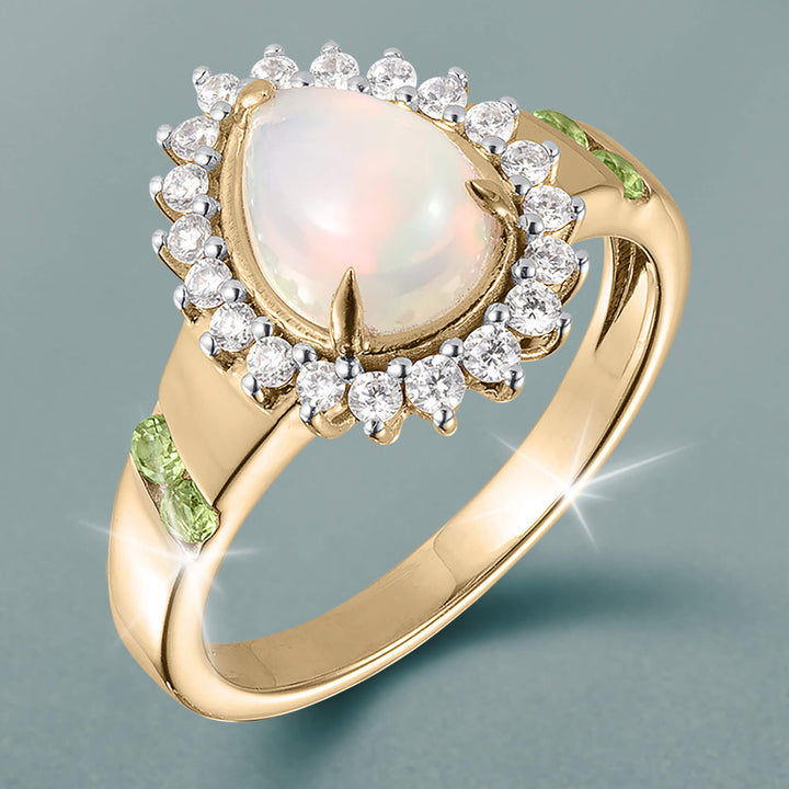 Opal Dew Drop Collection Set ring with luminous opal center, sparkling halo, and green gemstone accents, offered at Up To 75% Off Retail