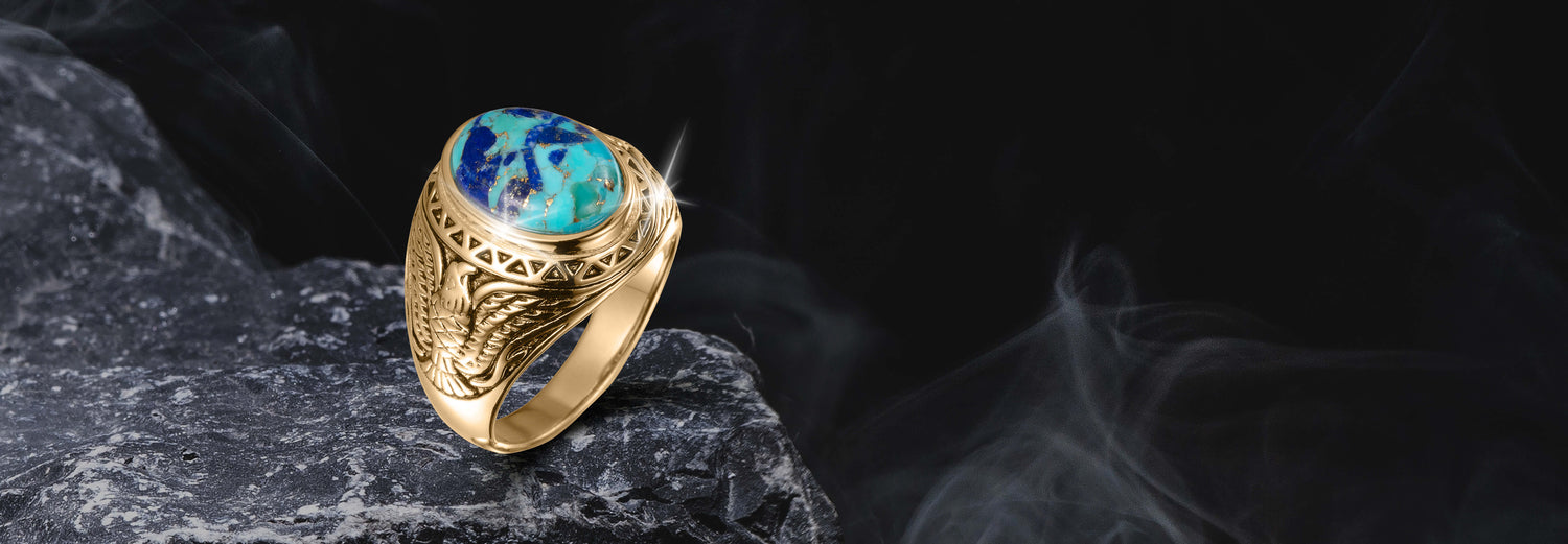 Wings Of Freedom Ring featuring a gold band with intricate eagle wing engravings and a polished turquoise stone centerpiece, designed as distinctive jewelry.