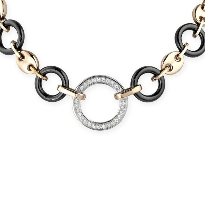 Close-up of a Java Ceramic Halo Necklace featuring stainless steel links with rose gold plating and a circular pendant encrusted with clear crystals, designed for women’s jewelry.