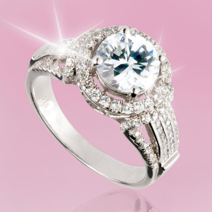 Regency Ring featuring a sterling silver band adorned with a large central sparkling gemstone surrounded by smaller glittering stones, designed for women’s jewelry.