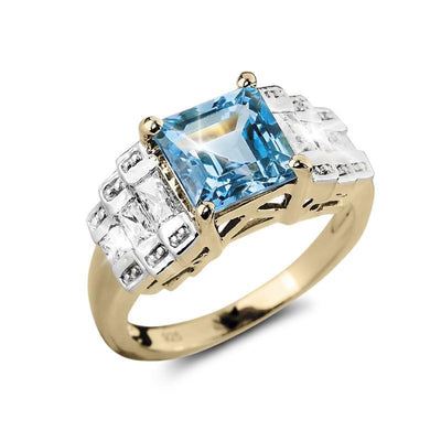 Oceana Blue Topaz Ring featuring a sterling silver and gold-plated band with a square blue topaz centerpiece and clear accent stones, designed for women’s jewelry collections.