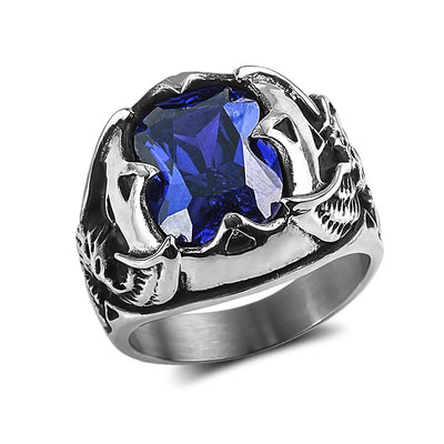 Men's Blue Eagle Ring featuring a large deep blue gemstone set in a stainless steel band with intricate eagle claw and skull designs, a bold men's jewelry piece.