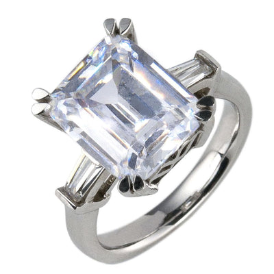 Billionaire Ring featuring a large rectangular sparkling stone set in sterling silver with rhodium plating, designed as elegant female jewelry.