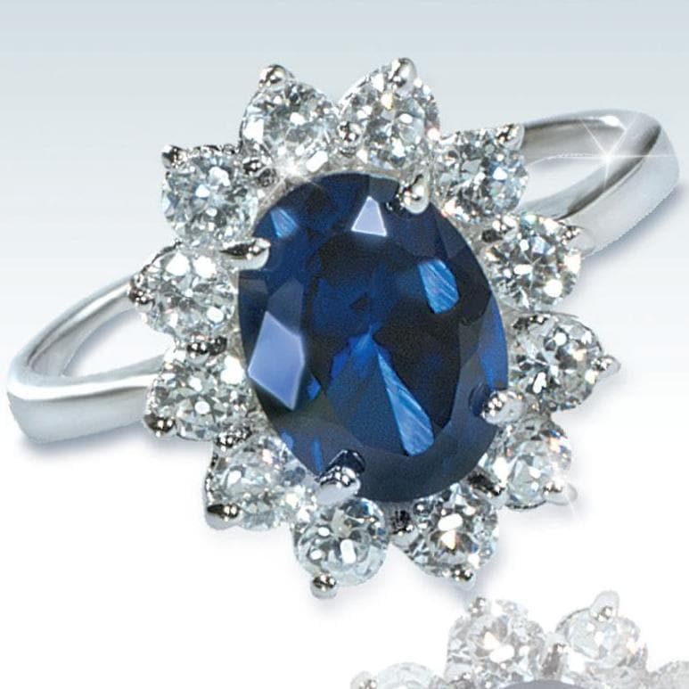Sterling Silver Forget Me Not Ring featuring a deep blue oval gemstone surrounded by sparkling clear stones, designed for female jewelry enthusiasts.