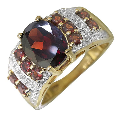 Marrakech Garnet Ring featuring a large garnet center stone surrounded by smaller garnets and sparkling accents, set in sterling silver with gold plating for a bold female jewelry statement.