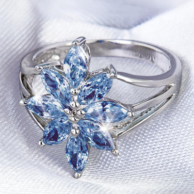 Tanzanite Flower Ring featuring a sterling silver band with rhodium plating, designed for females, showcasing a delicate flower shape crafted from marquise-cut tanzanite gemstones.